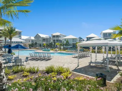 a pool at the resort with chairs and umbrellas at Prominence on 30A Pet Friendly Rentals by Panhandle Getaways in Watersound Beach