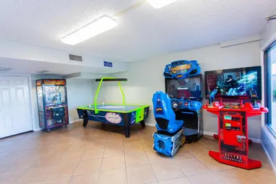 a room with a game room with a table and a game console at Summit 203 in Panama City Beach