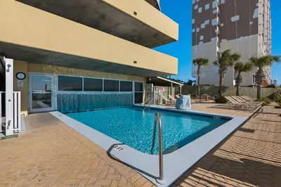 a swimming pool in front of a building at Emerald Isle 1406 by Emerald Coast Retreats in Panama City Beach