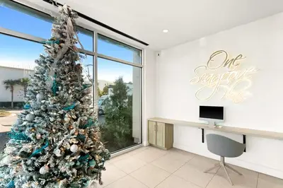 a christmas tree in a room with a desk at One Seagrove Place 1404 in Santa Rosa Beach