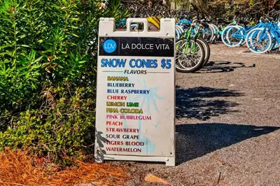 a sign for snow cones next to a group of bikes at High Pointe Resort 115 in Seacrest