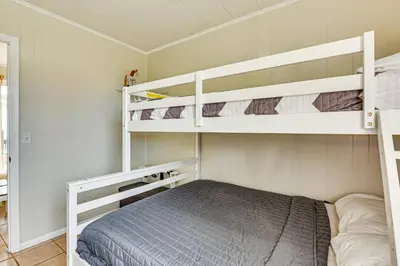 a small bedroom with two bunk beds in it at Steps to Sand! PCB Haven with Furnished Outdoor Area in Panama City Beach