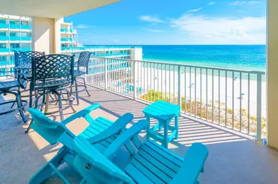 a balcony with blue beach chairs and the ocean at Sugar Sand at Ocean Reef in Panama City Beach