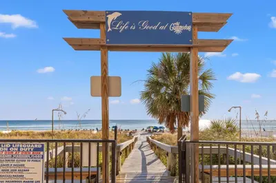 a boardwalk to the beach at a resort at Commodore 0806 in Panama City Beach