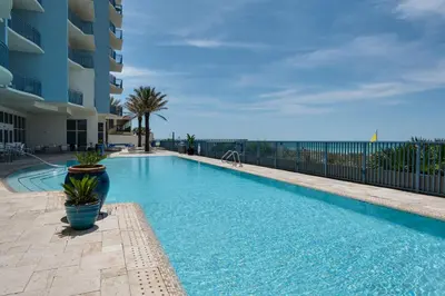 a swimming pool at a resort with a building at Sterling Breeze 307 by Emerald Coast Retreats in Panama City Beach