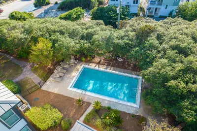 an overhead view of a swimming pool in a yard with trees at Inlet Dunes 105 l Community Pool l Across From The Beach in Inlet Beach