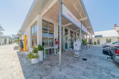 a store front with plants in front of it at Leeward 1 7 l Beachfront Condo with Stunning Views of the Water l Bike to Seaside in Seagrove Beach