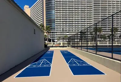 an empty tennis court in the middle of a city at Modern Condo! Free Beach Chairs & Pools by Dolce Vita Getaways PCB in Panama City Beach