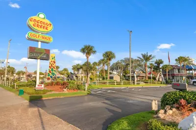 a sign for a fast food restaurant on a street at Billie Jean’s Bungalow! Cozy Edgewater Condo w/ Resort Amenities, Sleeps 6 in Panama City Beach