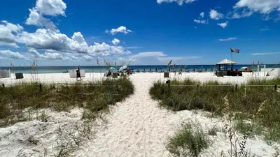 a white sandy beach with the ocean in the background at Ocean Reef 1002 in Panama City Beach