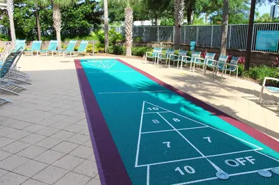a tennis court painted on the side of a swimming pool at Emerald Beach 1628 by Emerald Coast Retreats in Panama City Beach