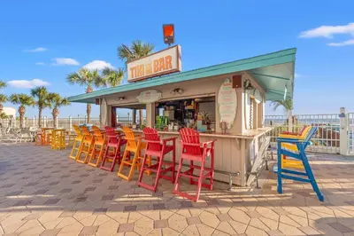 a row of colorful chairs in front of a restaurant at The Summit 1421 - Wake to Gulf Views in Panama City Beach