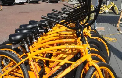 a row of yellow bikes parked on a street at Rise and Shine in Santa Rosa Beach