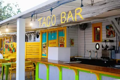 a taco bar with tables and chairs in front of it at 2 The Sea- Private Beach- Pool in Santa Rosa Beach