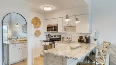 a kitchen with white cabinets and a marble counter top at 2 Condos Steps to Beach Ocean View Heated Pool The Sea Chord Salt Haus in Watersound Beach