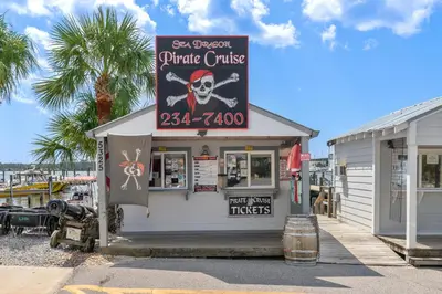 a restaurant with a sign for a pirate cruise at It’s Sea-esta Time! Sleep, Sun, & Sea on the 9th Floor! Sleeps 6! Beachfront! in Panama City Beach