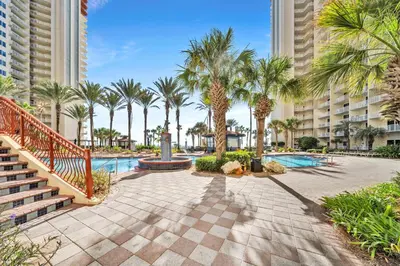 a resort with a swimming pool and palm trees at Shores of Panama 530 in Panama City Beach