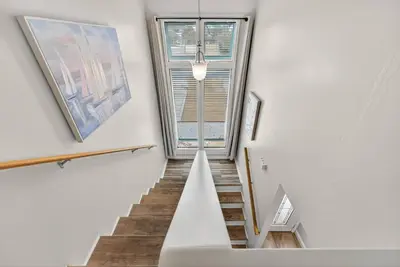 a staircase in a house with a window at Emerald Escape - 3 Blocks to Beach in Panama City Beach