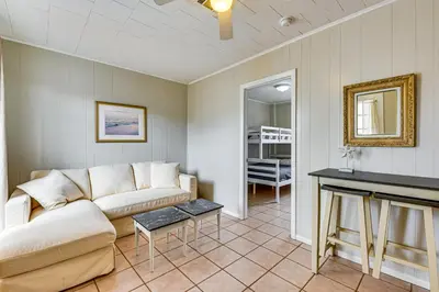 a living room with a couch and a table at Two by Sea Beachfront Private Home with Courtyard! in Panama City Beach