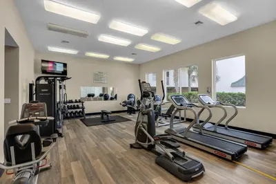 a gym with treadmills and cardio equipment in a room at Gulf-front 3-bedroom condo with bonus bunk room & pickleball in Santa Rosa Beach