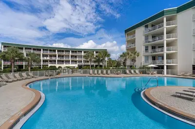 a swimming pool in front of a resort at Charming suite with spacious balcony pools tennis & pickleball in Santa Rosa Beach