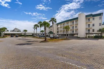 an empty parking lot in front of a building at Gorgeous 3-bedroom condo with stunning view spacious balcony & pickleball in Santa Rosa Beach