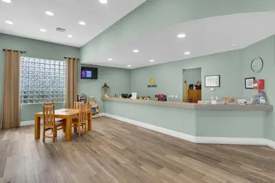 a waiting room at a pharmacy with a table and chairs at 4th-floor condo with beach ambience lagoon pool gym tennis & pickleball in Santa Rosa Beach