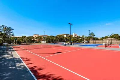a tennis court with two tennis courts at Airy beachfront condo with balcony views lagoon pool tennis & pickleball in Seacrest