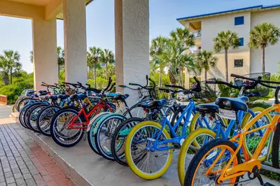 a row of bikes parked next to a building at Amazing High Pointe condo with grill hot tub pool tennis & pickleball in Seacrest