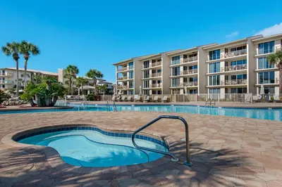 a swimming pool in front of a apartment building at Spacious getaway with Gulf view beach access tennis & pickleball in Seacrest