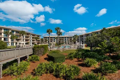 a view of a resort with trees and plants at Spacious getaway with Gulf view beach access tennis & pickleball in Seacrest