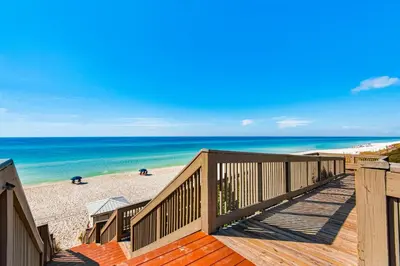 a view of the beach from the deck of a beach house at Condo with pickleball - steps from the Gulf & quick walk to dining & shops in Seacrest