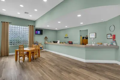 a waiting room at a pharmacy with a table and chairs at Beautiful 2nd-floor condo in Seagrove Beach with beach ambience & pickleball in Santa Rosa Beach