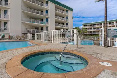 a small pool in front of a apartment building at Beautiful 2nd-floor condo in Seagrove Beach with beach ambience & pickleball in Santa Rosa Beach