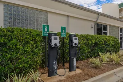 a row of parking meters in front of a building at Magical 3rd-floor condo with pools telescope for stargazing & pickleball in Santa Rosa Beach