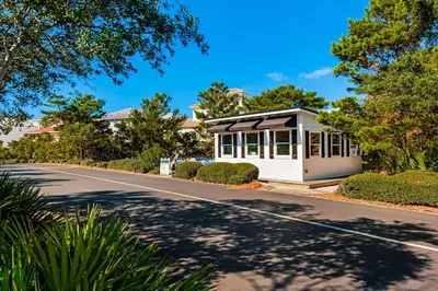 a house with a road in front of it at Coastal condo with lagoon pool bike rentals tennis pickleball & beach access in Seacrest