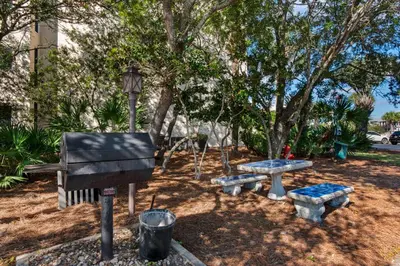 a park with a piano and a picnic table at Elegant abode overlooking the pool with beach access tennis & pickleball in Seacrest