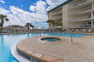 a swimming pool in front of a hotel at Lovely waterfront condo with balcony pool hot tub & pickleball in Santa Rosa Beach