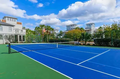a tennis court in front of some houses at Chic first-floor condo with Gulf & pool view & pickleball - steps to beach in Santa Rosa Beach
