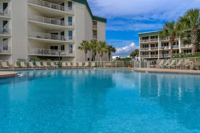 a large swimming pool in front of a building at Chic first-floor condo with Gulf & pool view & pickleball - steps to beach in Santa Rosa Beach
