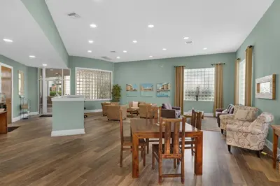 a living room with a table and chairs at Beach-view condo with outdoor pool hot tub sauna tennis BBQ & beach access in Santa Rosa Beach