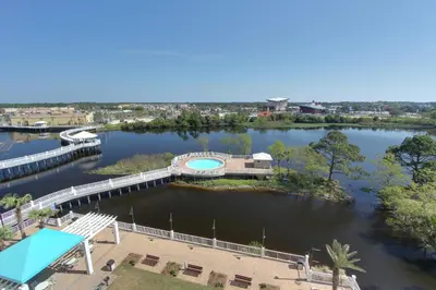 arial view of a river with a bridge and a building at Laketown Wharf Resort by Panhandle Getaways in Panama City Beach