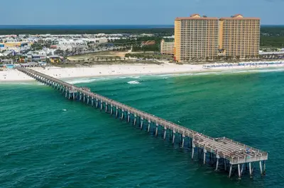 an aerial view of a pier over the ocean with a beach at Calypso 1-609 East in Panama City Beach
