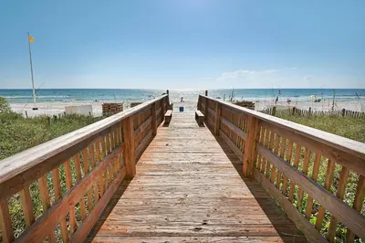 a wooden boardwalk leading to the beach at Celadon 309 in Panama City Beach