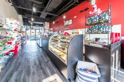 a store with red walls and a counter with pastries at Laketown Wharf 1326 in Panama City Beach