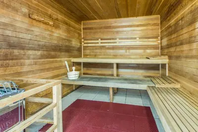 a sauna with wooden walls and wooden shelves at Ocean Villa Penthouse #2302 in Panama City Beach