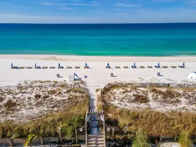 a beach with a bunch of sail boats on it at Sugar Beach C-2 in Panama City Beach
