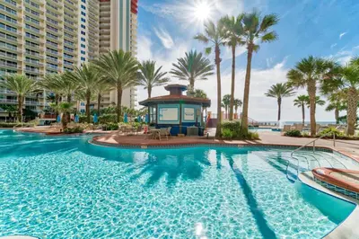 a swimming pool at a resort with palm trees at Shores of Panama by Panhandle Getaways in Panama City Beach