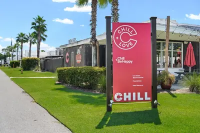 a red sign in the grass next to a sidewalk at Prominence on 30A Beach Homes by Panhandle Getaways in Watersound Beach