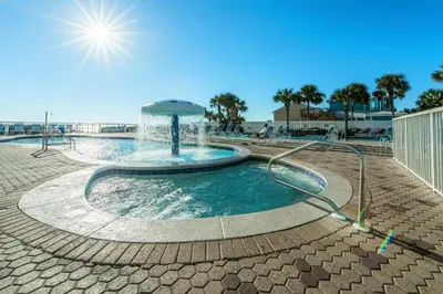 a swimming pool with a water fountain at Majestic Beach Towers 2-603 in Panama City Beach